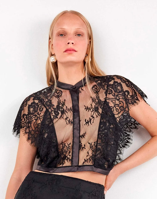 Camicetta in pizzo trasparente con dettagli eleganti
