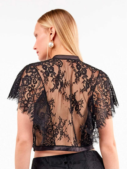 Camicetta in pizzo trasparente con dettagli eleganti